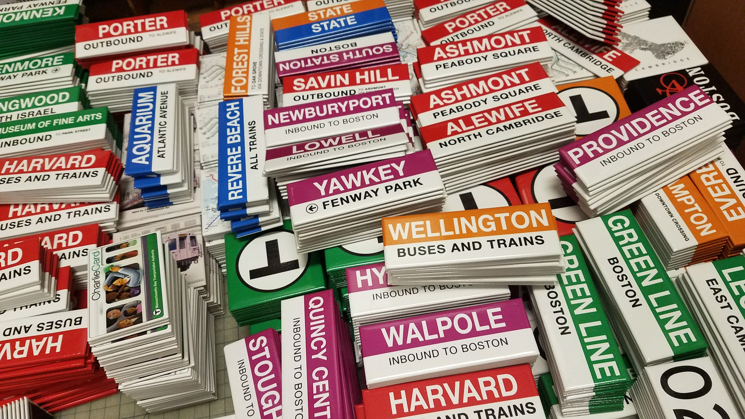 Photograph of Pile of MBTA Station Sign Magnets at Our Retail Store